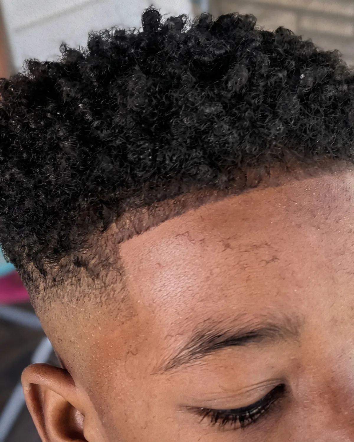 Tapered curls with a razor-sharp lineup