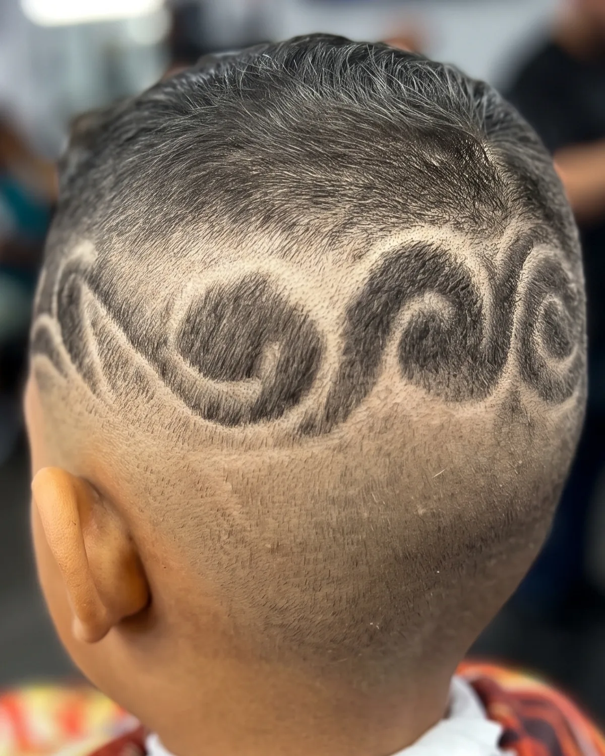 Freehand hair design carved into a fade